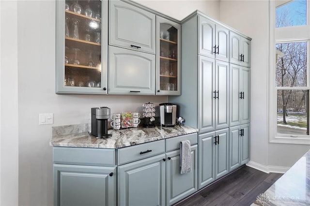 bar with gray cabinetry, dark hardwood / wood-style flooring, and plenty of natural light