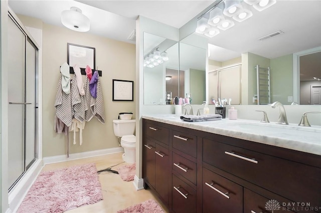 bathroom featuring an enclosed shower, vanity, and toilet