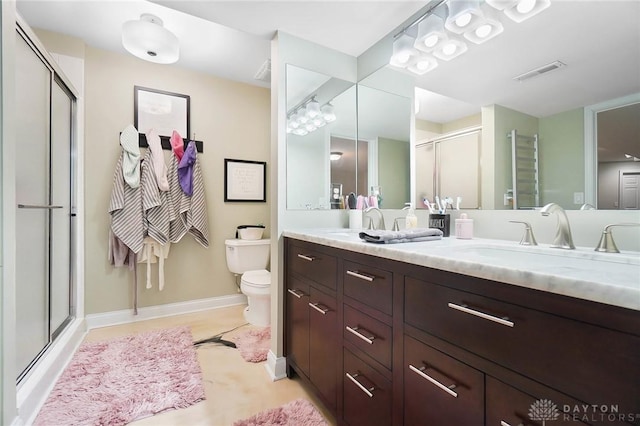 bathroom featuring a sink, a shower stall, toilet, visible vents, and baseboards