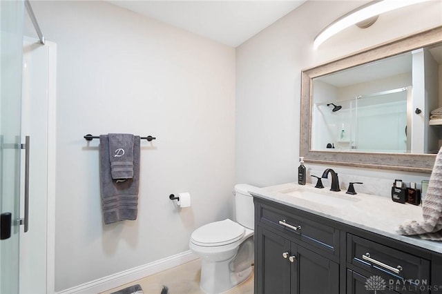 bathroom featuring vanity, toilet, and a shower with shower door