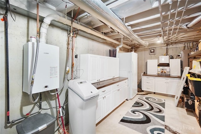 basement with white refrigerator and tankless water heater