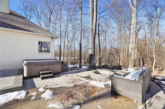 view of patio / terrace featuring an outdoor fire pit and a hot tub