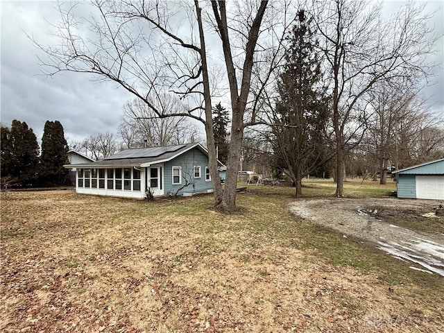 view of yard with a sunroom