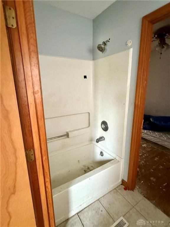 bathroom featuring tile patterned flooring and  shower combination