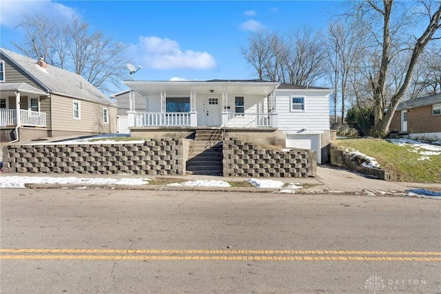 view of front of property with a garage and covered porch