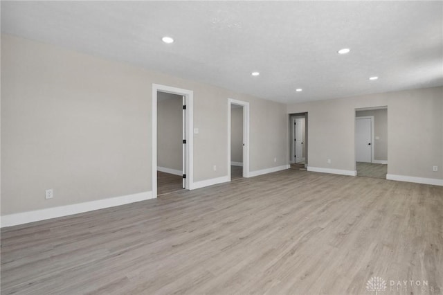 spare room featuring light hardwood / wood-style flooring