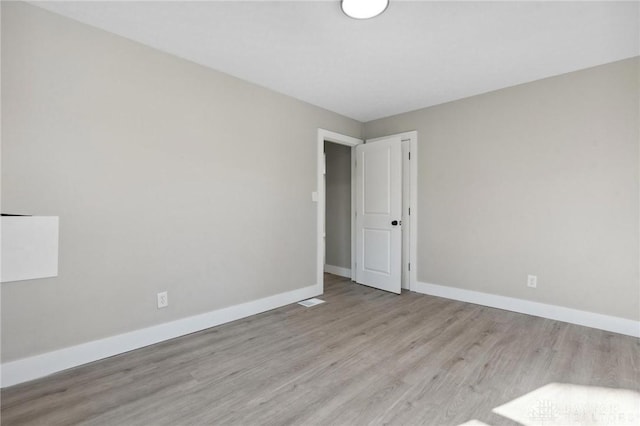 empty room with light hardwood / wood-style floors