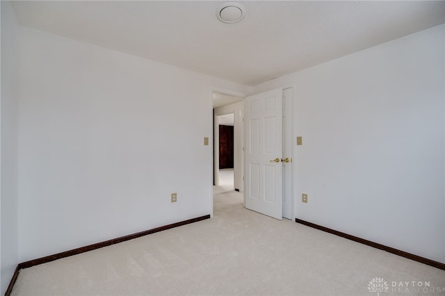 empty room featuring light carpet