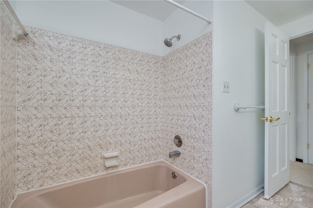 bathroom with tiled shower / bath combo and tile patterned floors