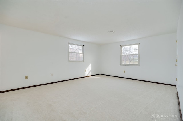 carpeted empty room with a wealth of natural light