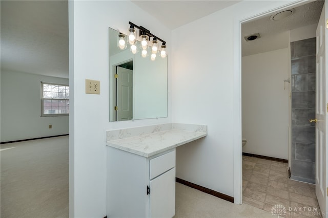 bathroom with vanity and toilet