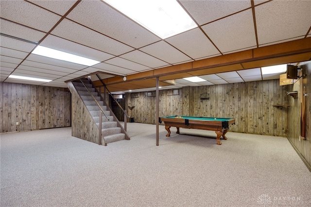 game room featuring pool table, carpet flooring, a drop ceiling, and wood walls