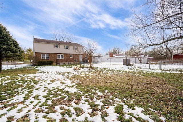 view of snow covered rear of property