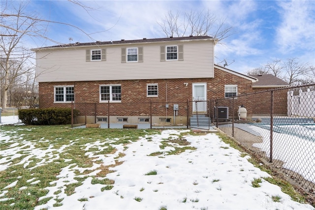 view of snow covered back of property