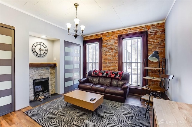 living room featuring a fireplace, a healthy amount of sunlight, dark hardwood / wood-style floors, and ornamental molding