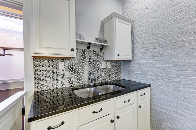 kitchen with sink, white cabinets, and decorative backsplash