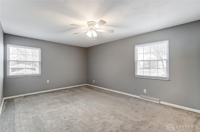 carpeted empty room featuring ceiling fan