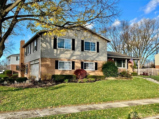 tri-level home with a garage and a front yard