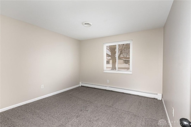 spare room with a baseboard heating unit and carpet flooring