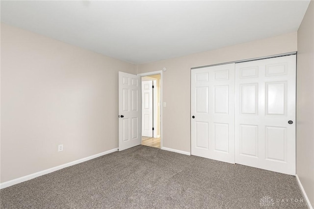 unfurnished bedroom with carpet flooring and a closet