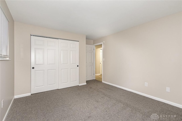 unfurnished bedroom with a closet and carpet flooring