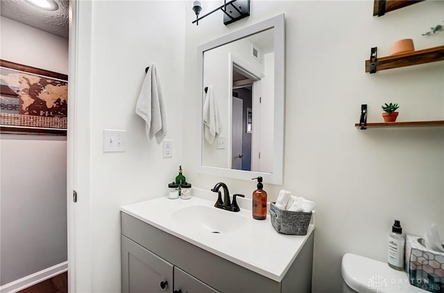 bathroom featuring vanity and toilet