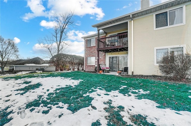 snowy yard with a balcony