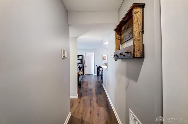 corridor with dark hardwood / wood-style flooring