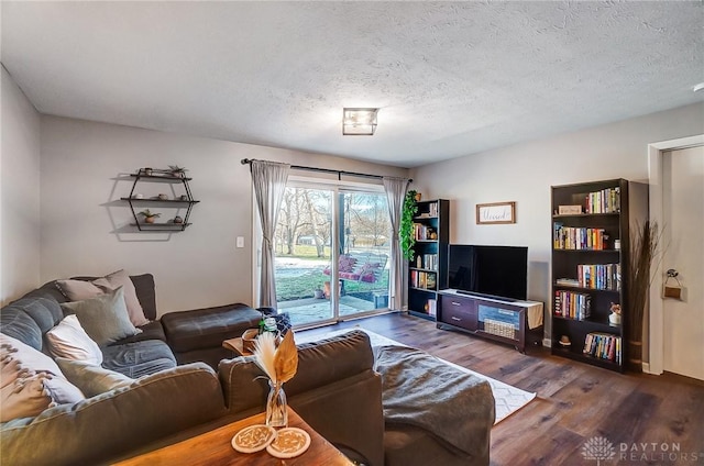 living room featuring dark hardwood / wood-style floors and a textured ceiling