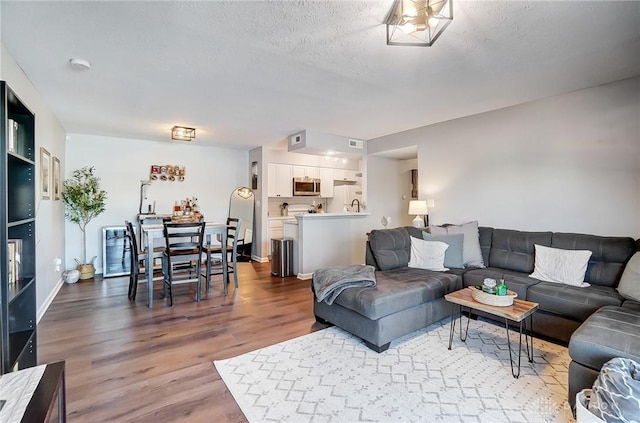 living room featuring hardwood / wood-style floors and a textured ceiling