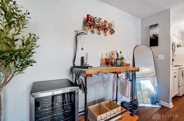 bar with butcher block countertops, white cabinetry, dark hardwood / wood-style floors, white range with electric cooktop, and beverage cooler