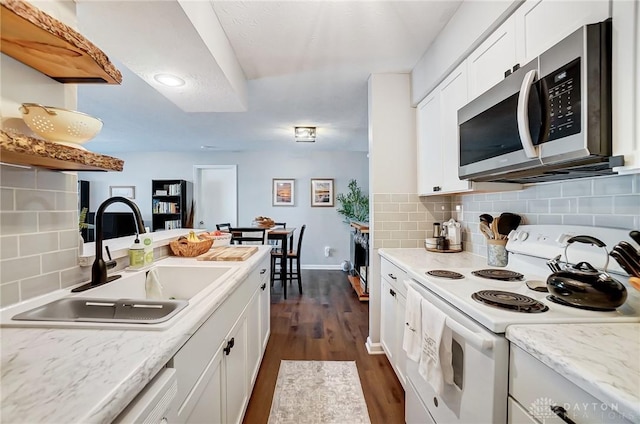 kitchen with sink, white cabinetry, dark hardwood / wood-style flooring, decorative backsplash, and white range with electric stovetop