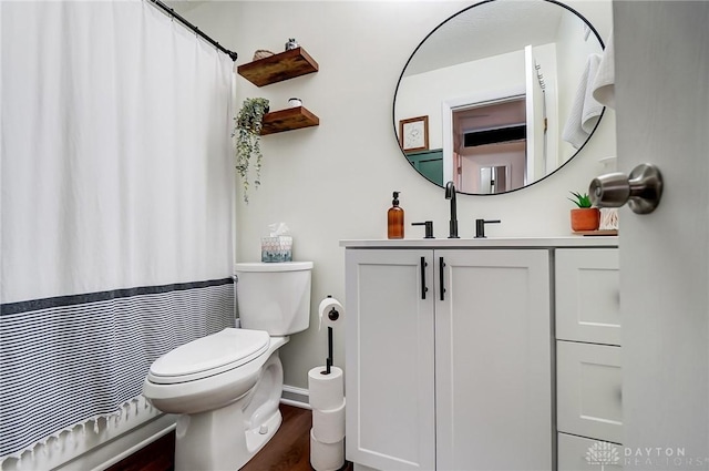 bathroom featuring hardwood / wood-style flooring, vanity, and toilet