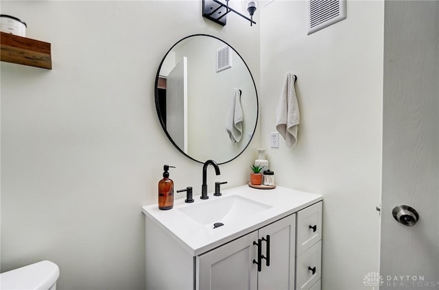 bathroom with vanity and toilet