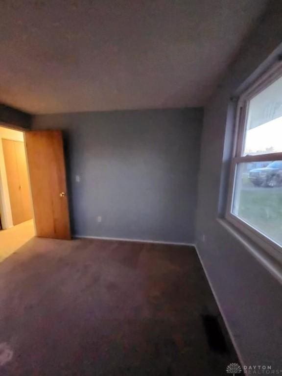 unfurnished room featuring carpet