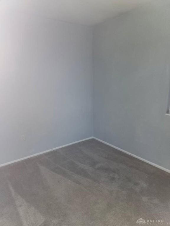 empty room with dark colored carpet