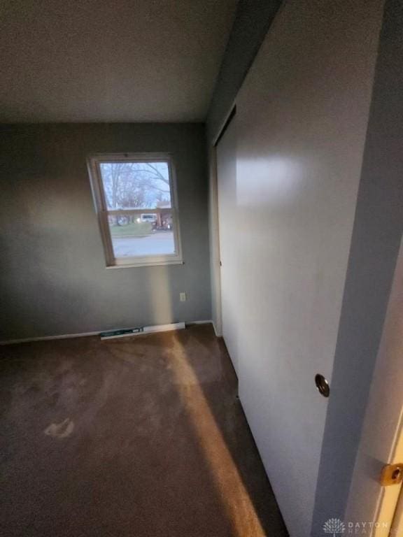 empty room featuring carpet floors and a textured ceiling