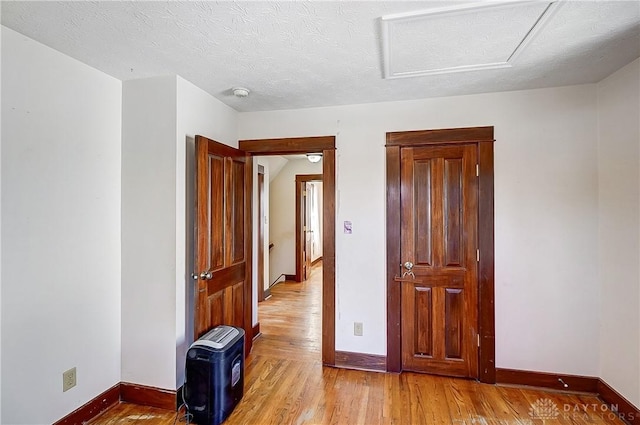 interior space with light hardwood / wood-style flooring and a textured ceiling