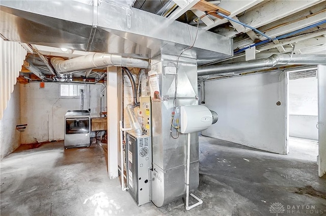 basement featuring washer / dryer, sink, and heating unit