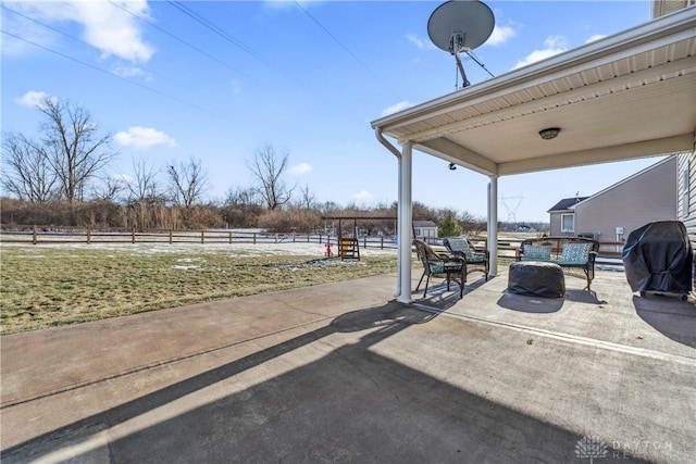 view of patio with a grill and a rural view