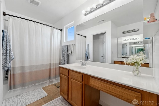 bathroom with vanity, shower / bathtub combination with curtain, and tile patterned floors