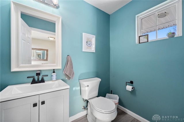 bathroom featuring vanity, hardwood / wood-style floors, and toilet