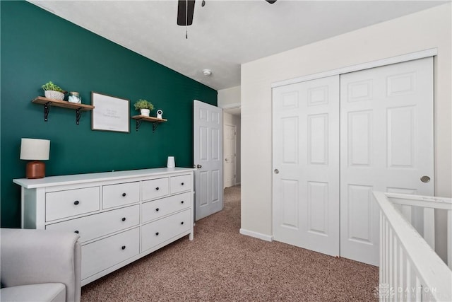 carpeted bedroom featuring a closet and ceiling fan