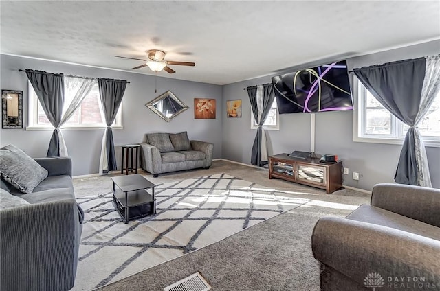 carpeted living room featuring ceiling fan