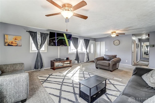 carpeted living room featuring ceiling fan