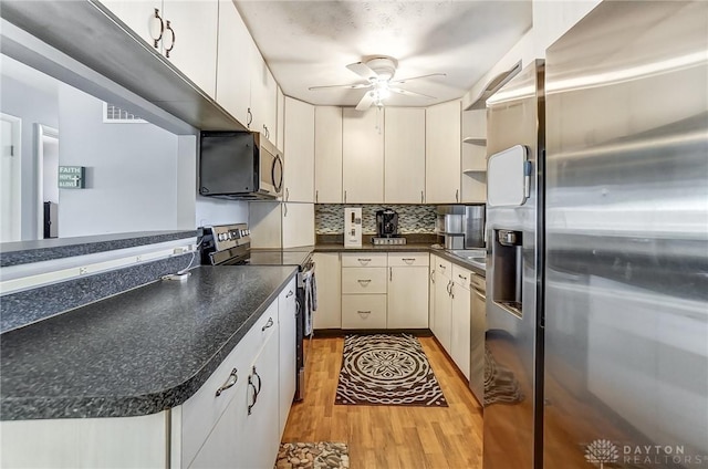 kitchen with white cabinetry, light wood-type flooring, appliances with stainless steel finishes, ceiling fan, and backsplash