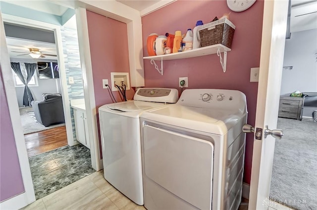 laundry room featuring separate washer and dryer, light colored carpet, and ceiling fan