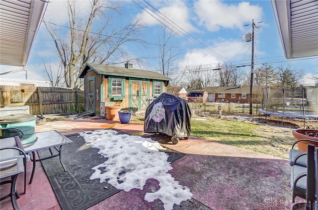 view of patio featuring an outdoor structure and a trampoline