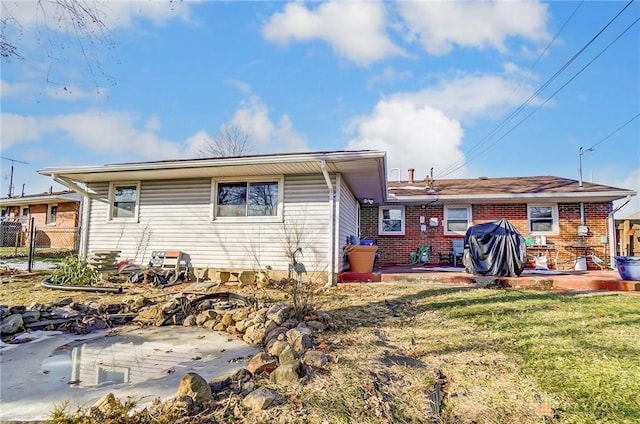 rear view of house featuring a yard and a patio