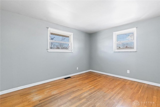 spare room featuring light hardwood / wood-style floors